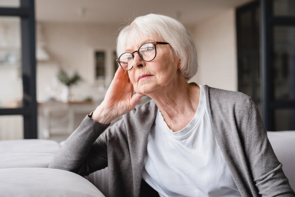 dementia-senior-woman-glasses-thinking-home